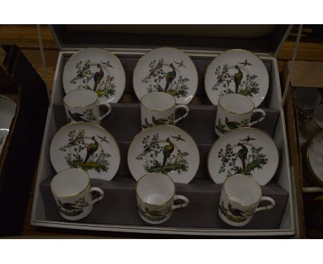 A Royal Worcester box set of six coffee cans and saucers decorated with exotic birds.