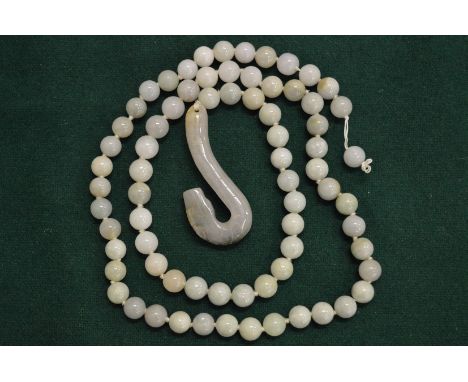 A jade bead necklace with carved jade pendant.