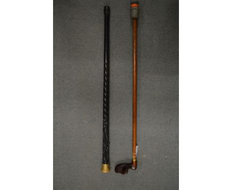 A gilt metal mounted carved wood walking stick and a modern walking stick.