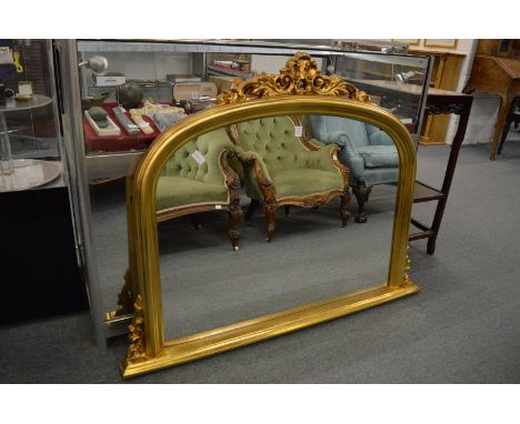 A Victorian style gilt framed over-mantel mirror.