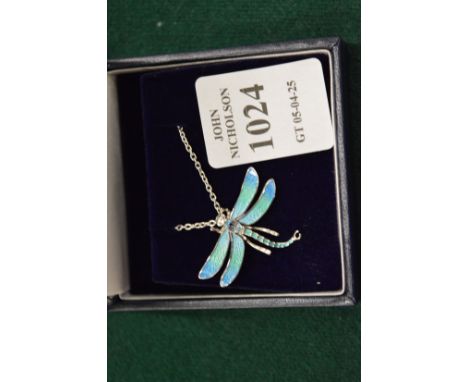 A sterling silver and enamel dragonfly pendant set with a blue topaz complete with chain.