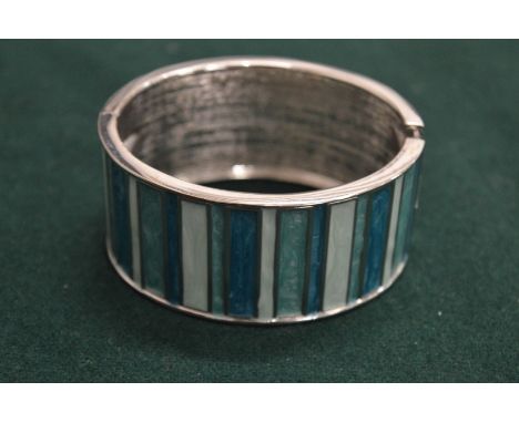 A silver and enamel cuff style bracelet.