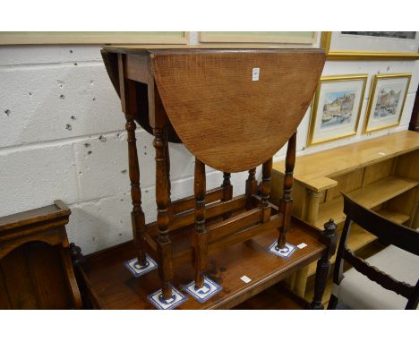 A small oak drop-leaf gate-leg dining table.
