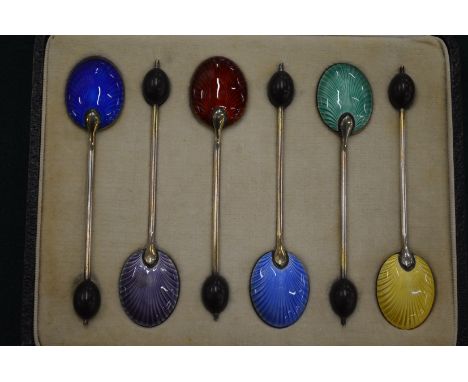 A set of six silver and enamel coffee bean spoons, cased.
