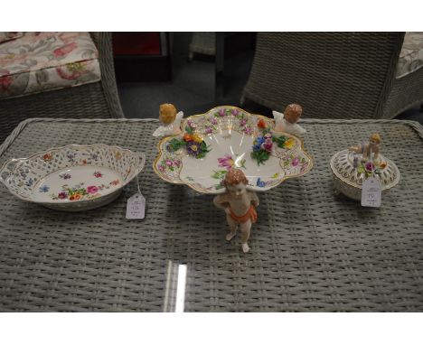 A Dresden floral decorated porcelain supported by cherubs and two other items.