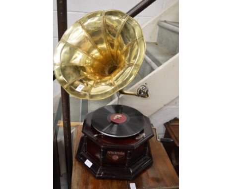 A reproduction gramophone with brass horn.