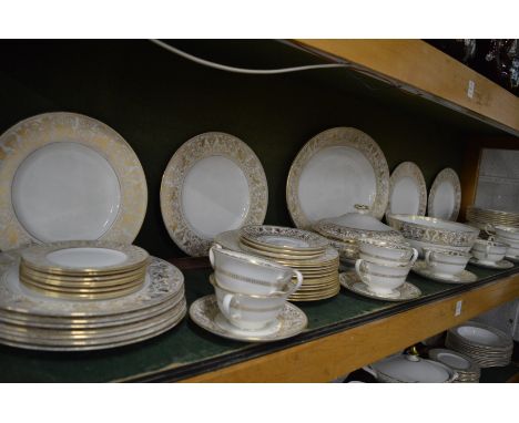 A comprehensive Wedgwood Gold Florentine dinner service.1 platter 44cm, 11 plates, 27.5cm, 12 small plates 23 cm, 1 bowl 24cm