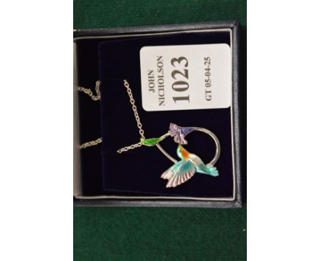 A sterling silver and enamel humming bird pendant and chain.