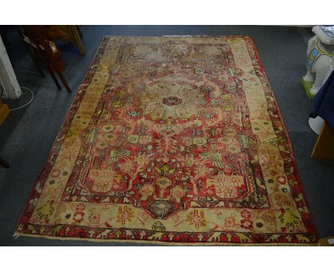 Persian design rug, pale red ground with all-over stylised decoration, 243cm x 156cm.