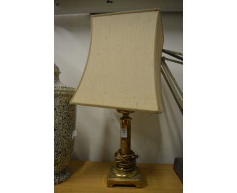 A brass table lamp.