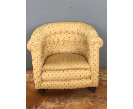 A yellow floral button upholstered Tub Chair on bun feet and casters 2ft 3in W x 2ft 7in H x 2ft 6in D 