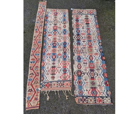 Two similar Kilim runners; together with a thin long runner, 335 x 93cm. (3)