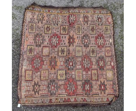 A Persian rug, having Aztec design to central field, 169 x 184cm.