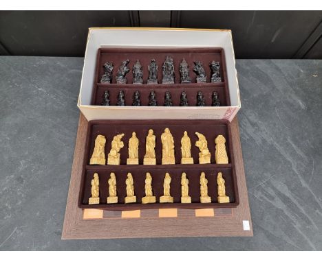 A Studio Anne Carlton Celtic resin chess set, king 11cm, pawn 8cm, boxed; with chess&nbsp; board, 50cm square.