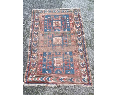 A Persian rug, having Aztec design, with three central medallions, 193 x 125cm.