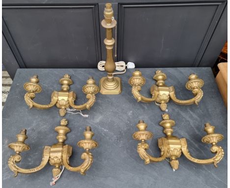 A set of four gilt brass twin branch wall lights, 39cm wide; together with a brass table lamp.