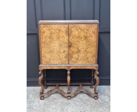 A circa 1930 figured walnut drinks cabinet, 111cm wide.