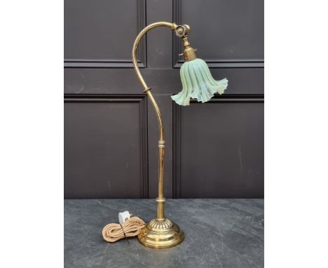 An Edwardian brass articulated table lamp, in the manner of Benson, with original Vaseline glass shade, 64.5cm high.