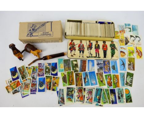 A hand carved Giant Tyrolean pipe contained in original box and a quantity of tea cards. [2]