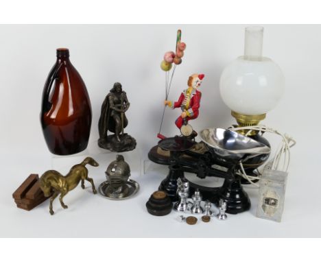 A mixed lot to include converted oil lamp, clown figure, scales, novelty table lighter and similar.