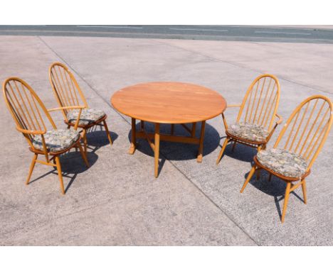 An Ercol drop leaf dining table with four Quaker dining chairs (2+2), table approximately 72 cm x 140 cm x 127 cm when open. 