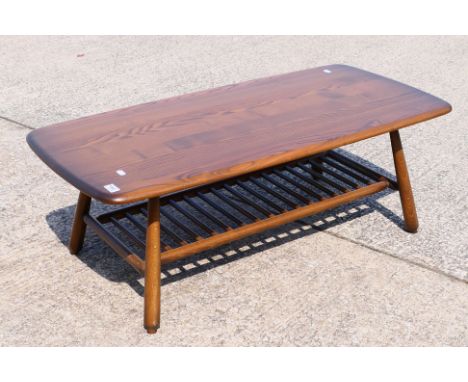 An Ercol coffee table with spindle undertier, approximately 36 cm x 104 cm x 50 cm.

NOTE: FURNITURE LOTS NEED TO BE COLLECTE