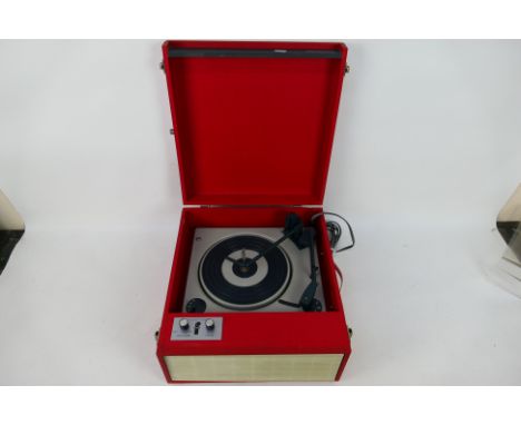 A vintage Fidelity portable record player in red and white case. Condition Report: Player powers on but turntable does not ap