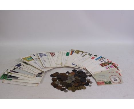 A small collection of first day covers and a quantity of UK and foreign coins / tokens.