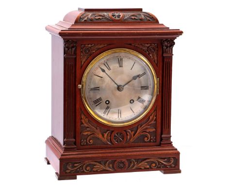 Table clock in walnut case with beautifully carved floral decor, movement marked W &amp; H Sch, 37 cm high