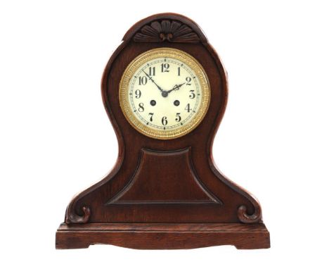 Table clock in oak case with carved crest, 38 cm high