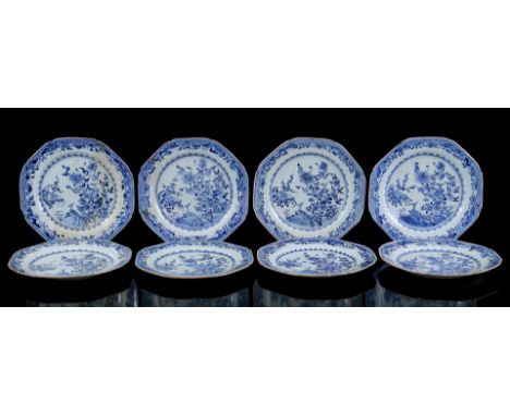 8 octagonal porcelain dishes with blue and white decor of birds in a flower garden and richly decorated rim with patterns and