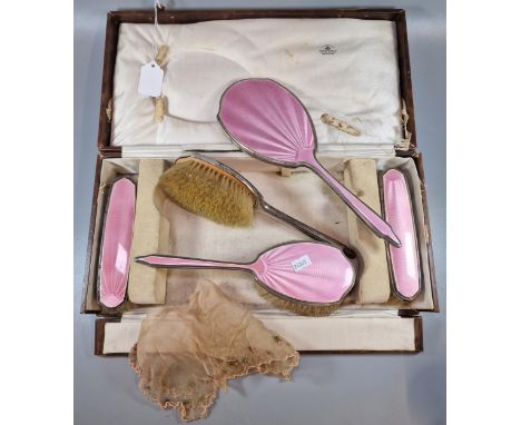 Mappin &amp; Webb Ltd. London, a cased five piece silver and pink guilloche enamel vanity set, comprising four hand brushes a