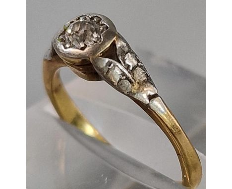 Gold diamond solitaire ring with white metal mounts and shoulders. 2.4g approx. Size K. (B.P. 21% + VAT)