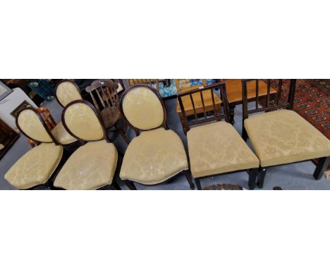Set of four mahogany framed upholstered dining chairs with oval padded backs and stuff-over seats on square legs with spade f