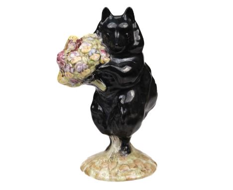 * Beswick. Duchess with Flowers, from Beatrix Potter, pottery figurine, depicting a black dog holding a bunch of flowers, gol