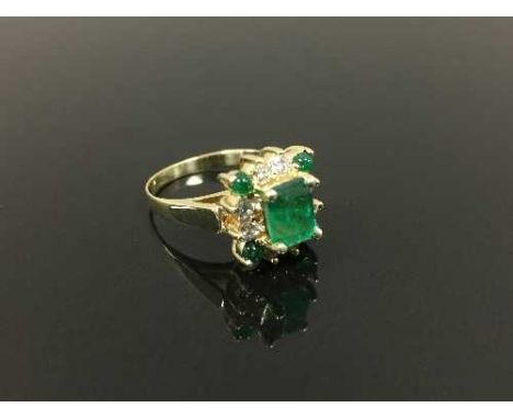 An emerald and diamond ring in high carat gold, size K. CONDITION REPORT: Good condition, the shank apparently unmarked.