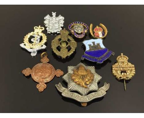 A selection of vintage medals and badges. (10) CONDITION REPORT: Lot includes - Cheshire regiment badge, enamelled 'Firmitas'