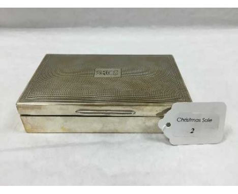 A silver cigarette box, London 1963, width 14.3 cm, 380.5g. CONDITION REPORT: With engine turned lid bearing three initials '