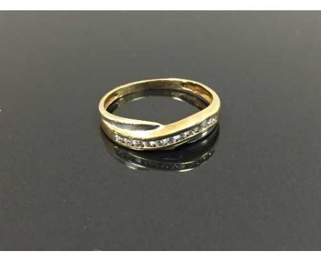 A 9ct two-tone gold cross-over ring, size K. CONDITION REPORT: Set with cubic zirconia.