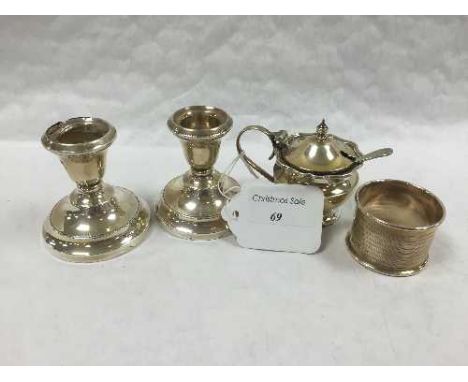 A pair of small silver squatt candlesticks, Birmingham 1936, together with a silver napkin ring and a silver mustard pot with