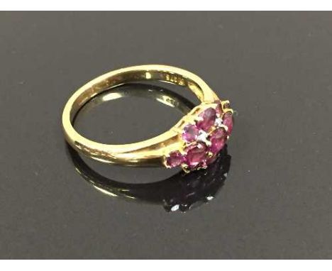 A 9ct gold diamond set cluster ring with purple gemstones, 3.2g, size R/S. CONDITION REPORT: Good condition.