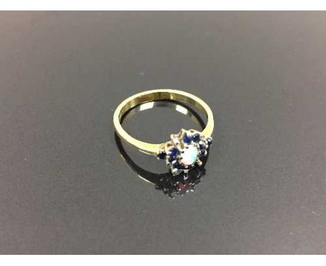 An 18ct gold opal cluster ring, size O. CONDITION REPORT: Good condition, missing a small sapphire stone.