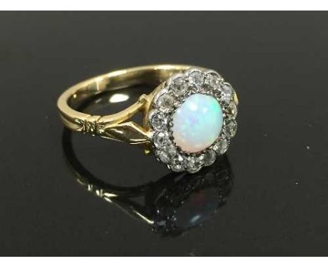 An 18ct gold antique opal and diamond cluster ring, size M. CONDITION REPORT: Good conditions.