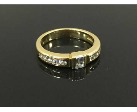 An 18ct gold diamond ring, set with an emerald cut diamond, size J/K. CONDITION REPORT: Good conditions.