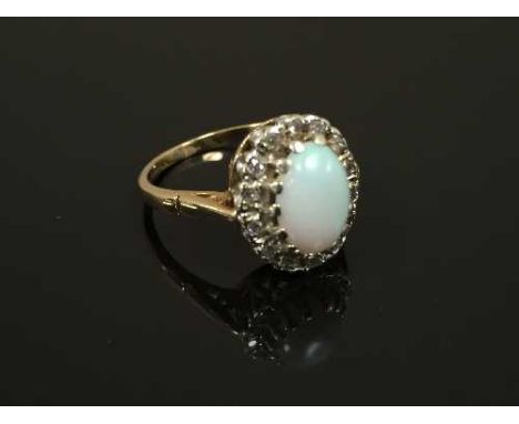 A 9ct gold opal and diamond cluster ring, 3.2g, size M. CONDITION REPORT: Good condition.