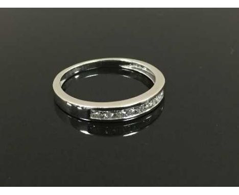 A platinum princess cut diamond half eternity ring, size J/K. CONDITION REPORT: Good conditions.