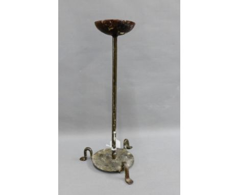 Iron candlestick on circular base with three outswept feet, 39cm high 