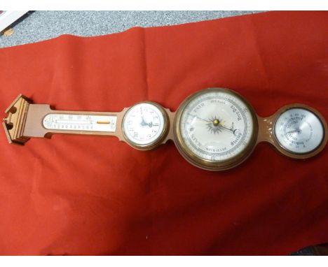 A Salem mahogany finish barometer, with clock, temperature and realtive humidity dials, 67 cm approx