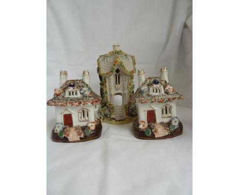 Three Staffordshire pottery pastille burners, two of the same shape, cottage size with double chimneys, applied moss-work and