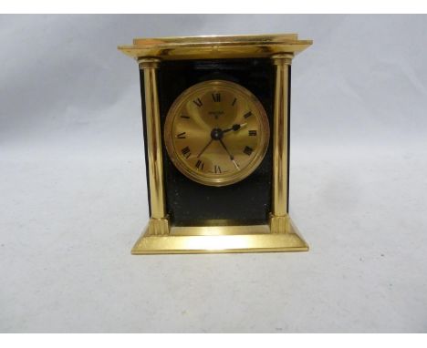 A Swiza 8 traveling alarm clock, brass and black enamel finish, presentation inscription, 8.5cm high approx 